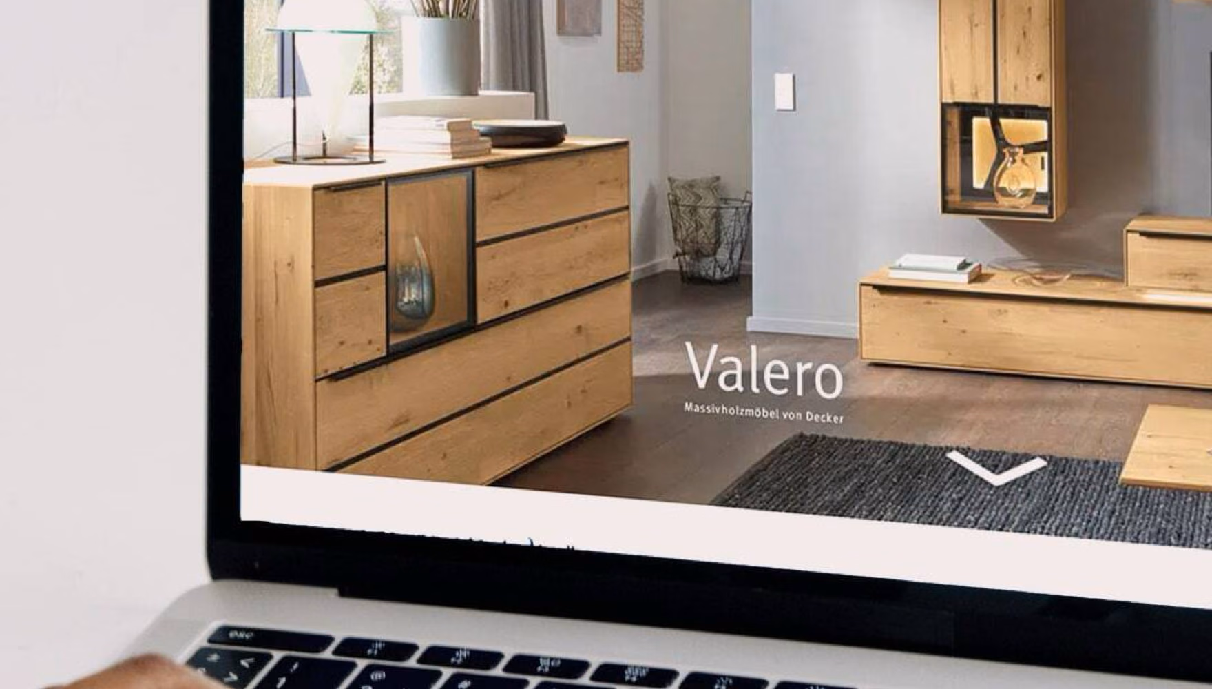 Hands type on a laptop showing the Decker website and its Valero solid wood collection.