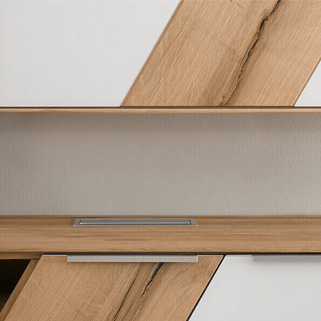 A solid wood wall unit with white fronts and a diagonal oak inlay runs along a pale wall above a long oak sideboard.