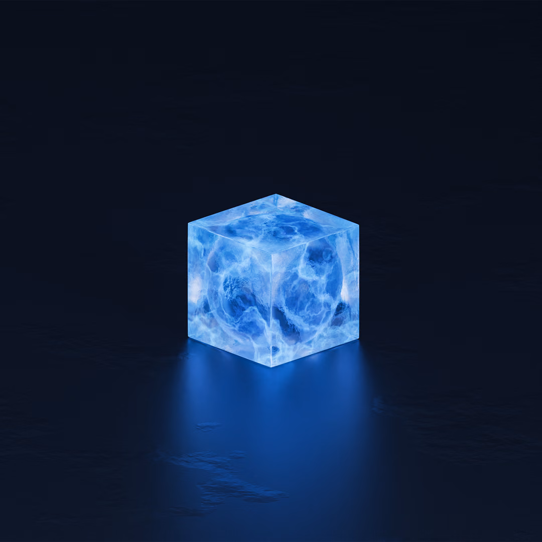 A single translucent blue cube glows on a dark reflective surface, its light spilling onto the floor in front of it.