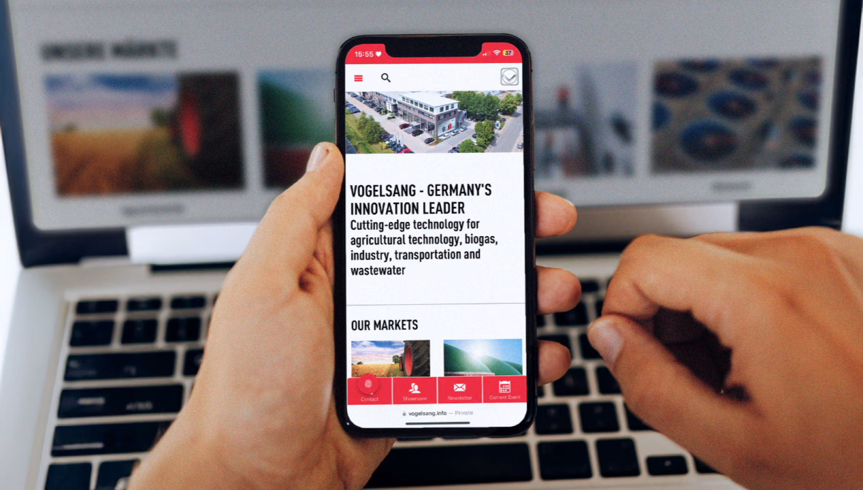 Two hands hold a phone showing Vogelsang's mobile site with an "our markets" list, in front of a laptop showing the same page in German.