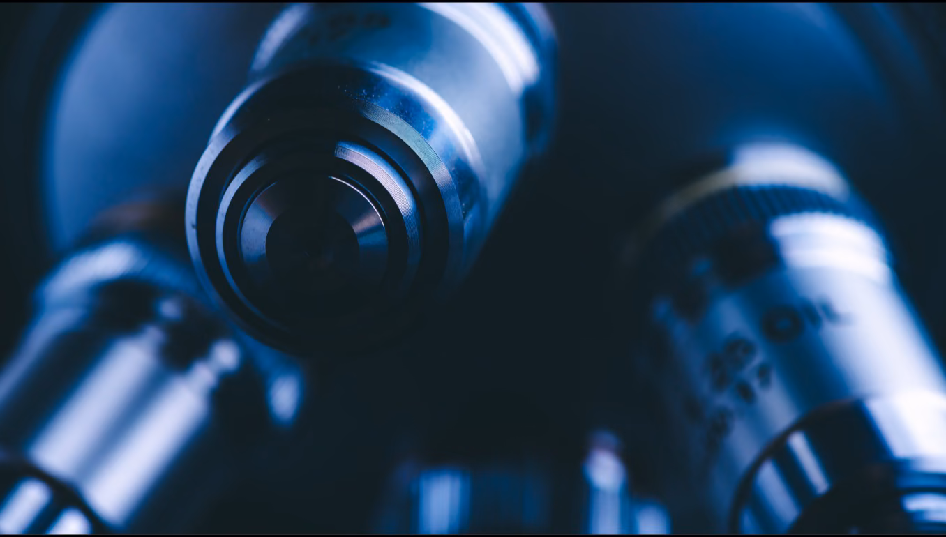 Microscope objectives in blue light, close up.