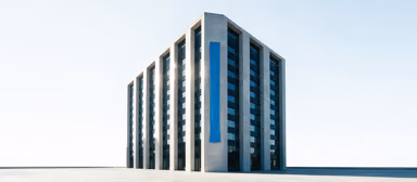 A tall corporate headquarters building against a bright sky with a ribbon-blue banner hanging down its facade.